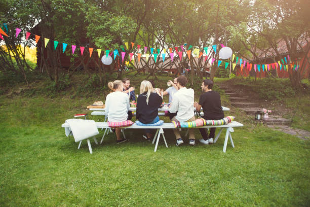friends enjoying at garden party in back yard - garden decoration stock pictures, royalty-free photos & images