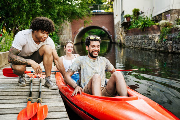 friends getting ready to go paddling in kayak - travel stock pictures, royalty-free photos & images