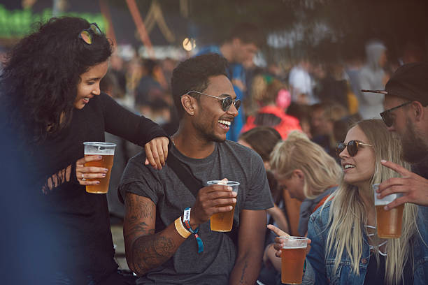 friends hanging out with beers at festival - concert stock pictures, royalty-free photos & images