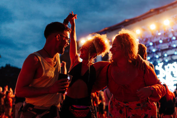 friends having fun drinking beer and dancing at concert - concert stock pictures, royalty-free photos & images