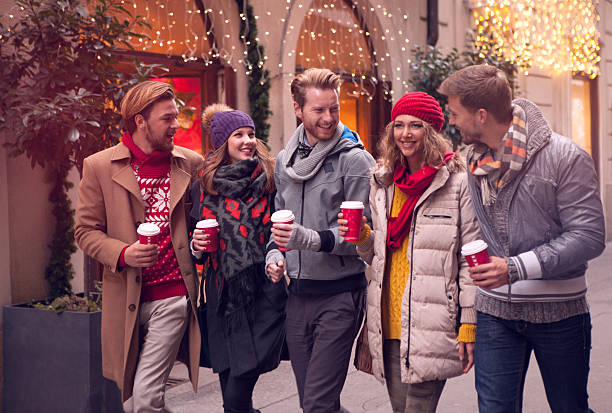 friends having fun outdoors in winter city. - junk food stock pictures, royalty-free photos & images