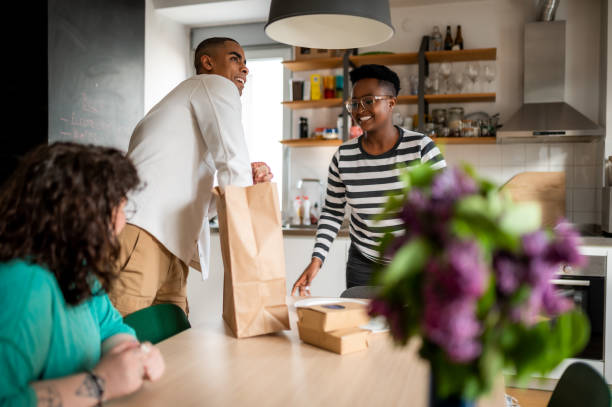 friends having lunch at home - junk food stock pictures, royalty-free photos & images