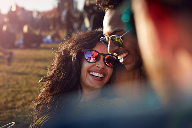 friends laughing at big festival - concert stock pictures, royalty-free photos & images