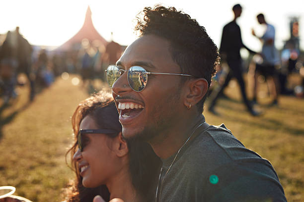 friends laughing at big festival concert - concert stock pictures, royalty-free photos & images