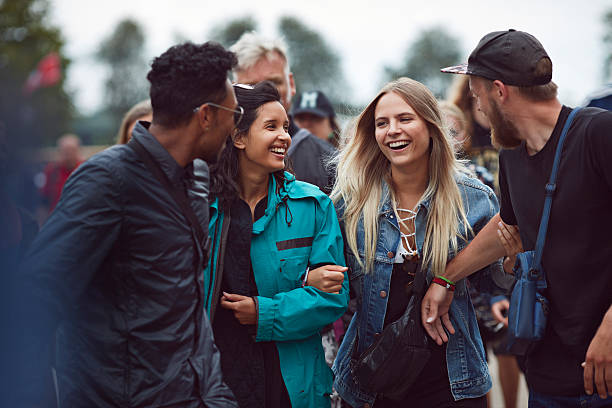 friends laughing together at outside festival - concert stock pictures, royalty-free photos & images