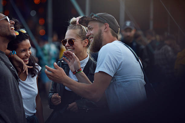 friends laughing together & clapping at concert - concert stock pictures, royalty-free photos & images