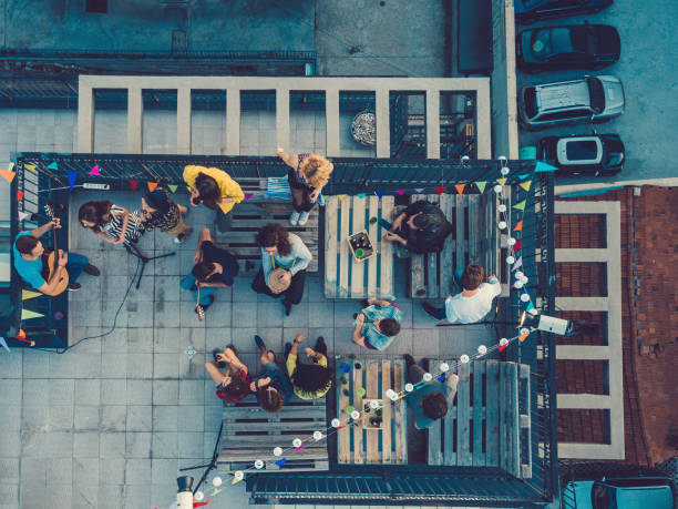 friends listening to a music band on the rooftop - concert stock pictures, royalty-free photos & images
