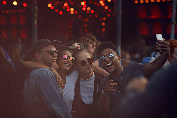 friends making selfie at concert - concert stock pictures, royalty-free photos & images