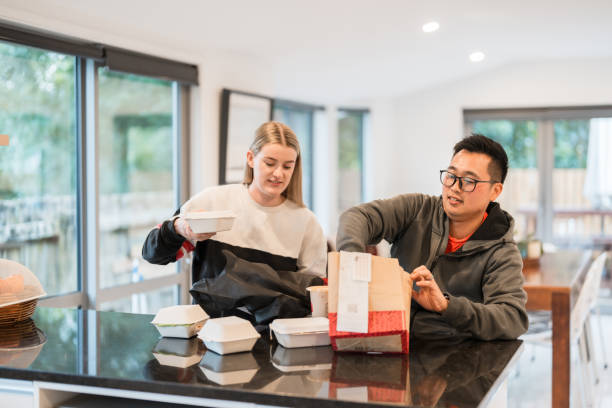 friends opening delivery box. - junk food stock pictures, royalty-free photos & images