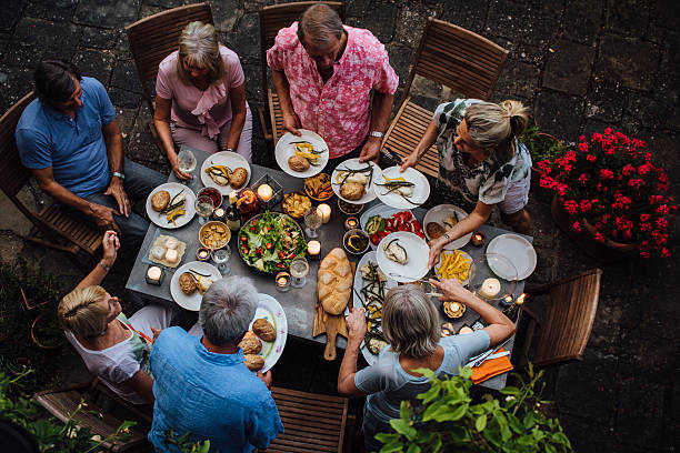 friends outdoors dining - food stock pictures, royalty-free photos & images