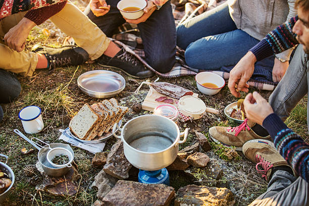 friends preparing breakfast at campsite - food stock pictures, royalty-free photos & images