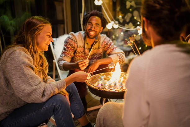 friends roasting marshmallows at back yard - garden decoration stock pictures, royalty-free photos & images