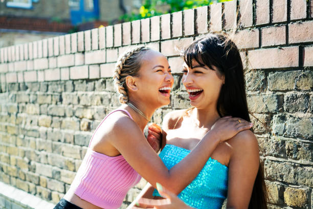 friends sharing a joke - fashion stock pictures, royalty-free photos & images