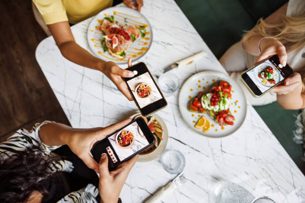 friends sharing food photography fun - food stock pictures, royalty-free photos & images