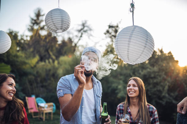 friends smoking and drinking at a party - garden decoration stock pictures, royalty-free photos & images