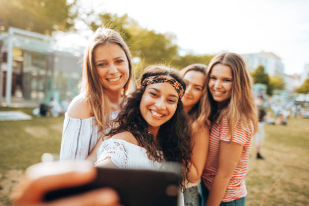 friends take a selfie in the park - concert stock pictures, royalty-free photos & images