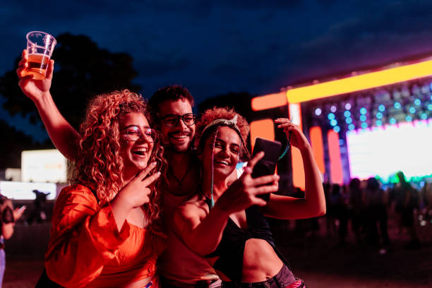 friends take selfie at a concert night. - concert stock pictures, royalty-free photos & images