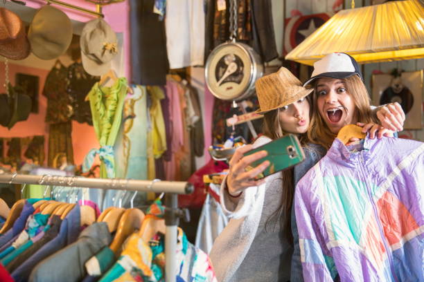 friends taking selfie in thrift store - fashion stock-fotos und bilder