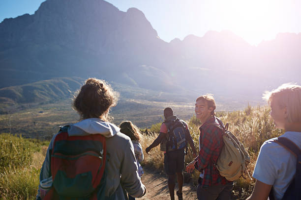 friends trekking in the mountains and laughing - travel stock pictures, royalty-free photos & images