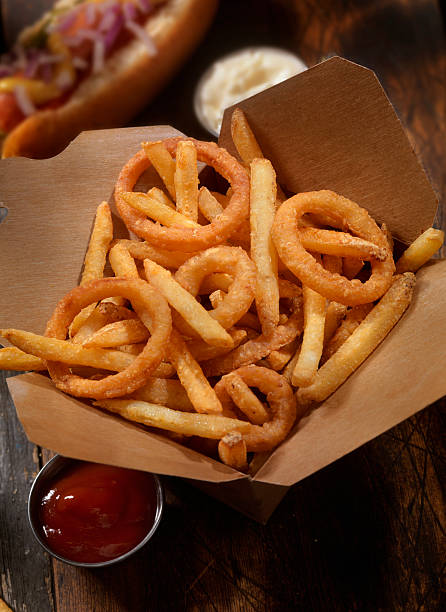 frings - french fries, onion rings and a hotdog - junk food stock pictures, royalty-free photos & images