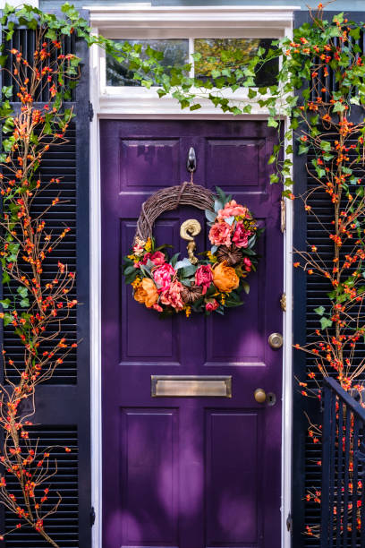 front door and shutters adorned with floral decor - garden decoration stock pictures, royalty-free photos & images