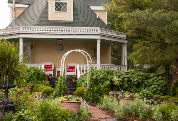 front porch with ice tea and wicker furniture overlooking gardens - garden decoration stock pictures, royalty-free photos & images