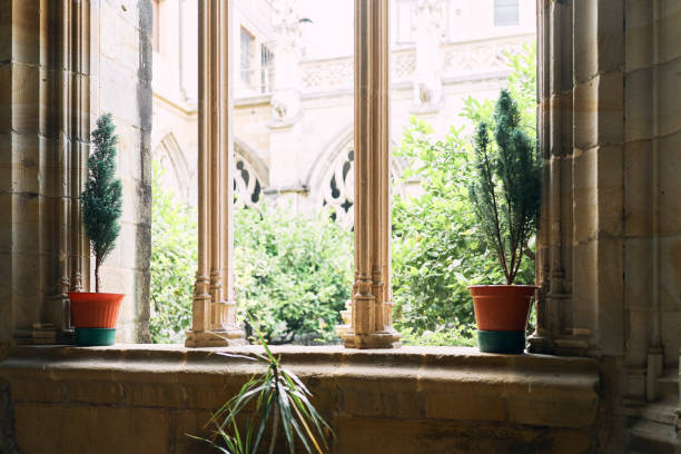 front view of a window inside a hotel with two vases and a garden in the background - garden decoration stock pictures, royalty-free photos & images