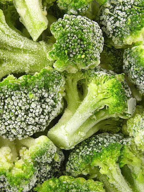 frozen broccoli background - food stock pictures, royalty-free photos & images