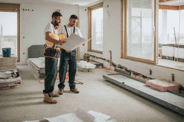 full length of construction workers analyzing blueprints in the apartment. - home decoration stock pictures, royalty-free photos & images