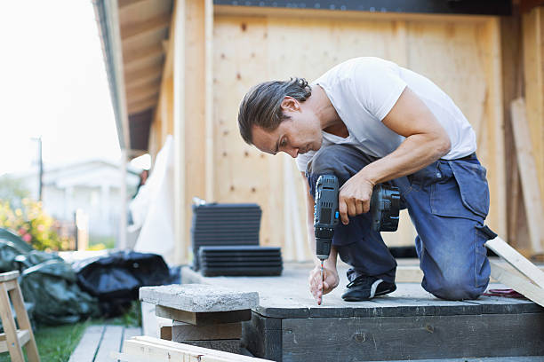 full length of man using cordless screwdriver nail into floorboard - home decoration stock pictures, royalty-free photos & images