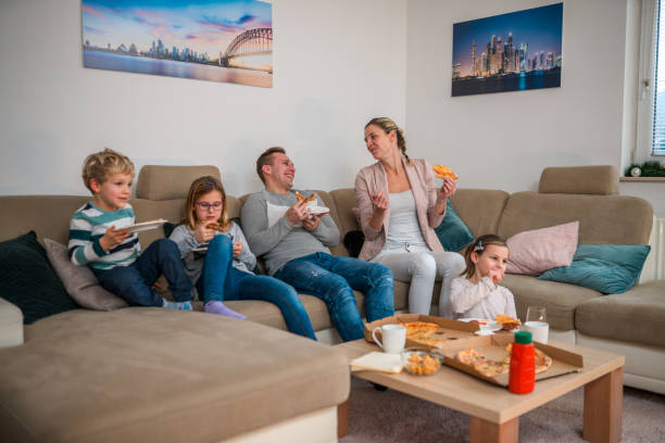 fun movie and pizza night with family - junk food stock pictures, royalty-free photos & images