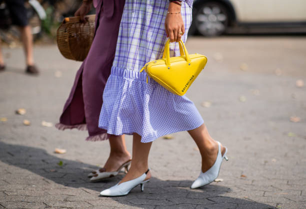 Funda Christophersen, Trine Kjaer wearing yellow Balenciaga triangle bag seen outside Holzweiler during the Copenhagen Fashion Week Spring/Summer...