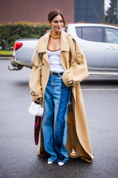 Gala Gonzalez is seen wearing beige long trench coat, white shirt, two tone denim jeans a white bag outside Gucci during the Milan Fashion Week...