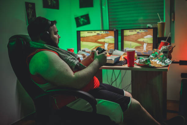 gamer playing video games - junk food stock pictures, royalty-free photos & images