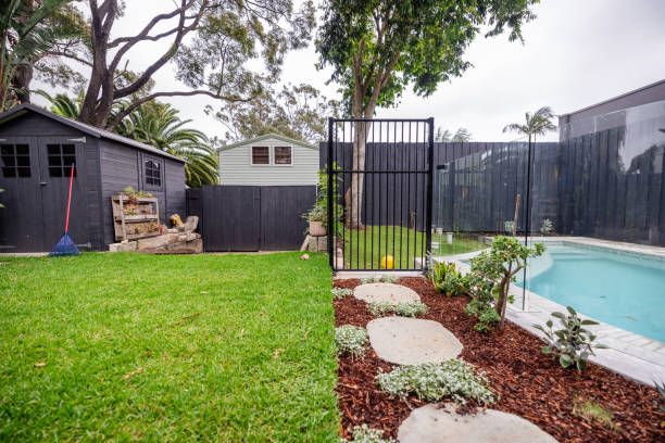garden view with gate leading to fenced pool area - garden decoration stock pictures, royalty-free photos & images