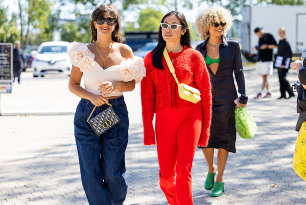 Gili Biegun and Miki Cheung wearing red kint, pants seen outside Samsøe Samsøe during Copenhagen Fashion Week Spring/Summer 2023 on August 10, 2022...