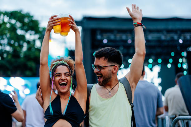 girl dancing with beer in hands - concert stock pictures, royalty-free photos & images