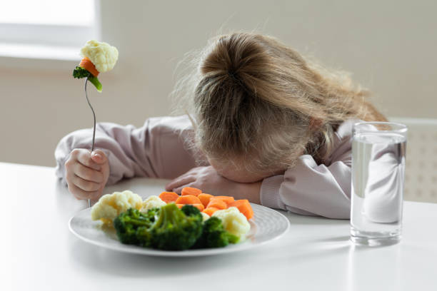 girl does not like to eat vegetables - junk food stock pictures, royalty-free photos & images