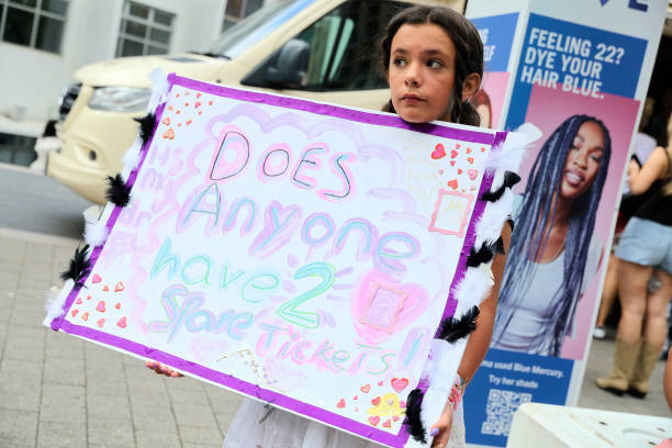 Girl holds up a sign asking if anyone has a spare ticket, as Taylor Swift fans, also known as "Swifties", arrive at Wembley Stadium ahead of her...