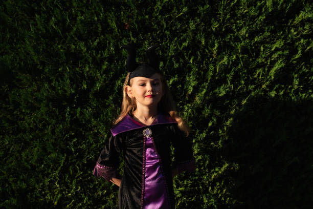 girl in a festive costume outside. halloween. candy or death. pumpkin. holiday. masquerade. - garden decoration stock pictures, royalty-free photos & images