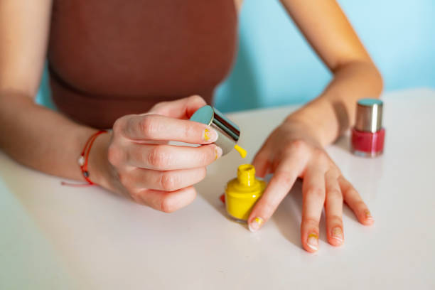 girl painting her nails at home with nail polish - nails art stock pictures, royalty-free photos & images