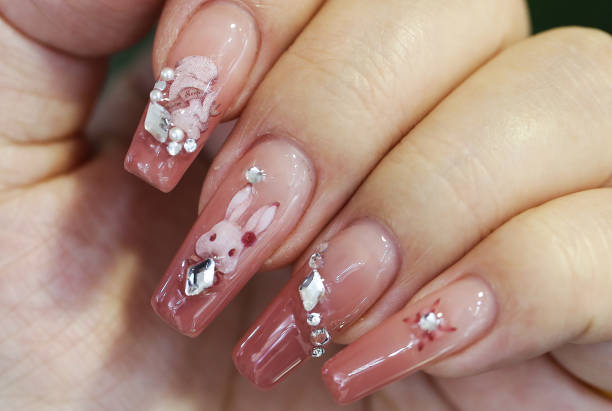 Girl shows a Chinese zodiac rabbit nail art in Lianyungang City, East China's Jiangsu Province, Jan 11, 2023.