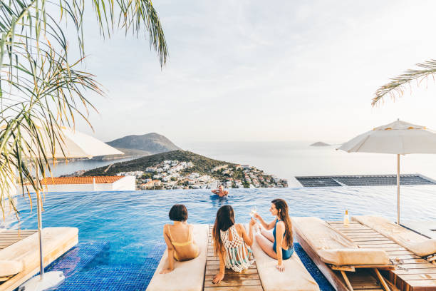 girlfriends having fun on pool party. cheers to the best weekend. - travel stockfoto's en -beelden