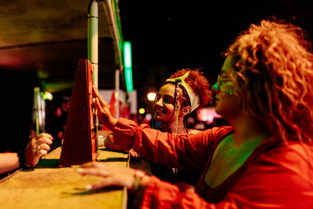 girls buying beverages at festival - concert stock pictures, royalty-free photos & images