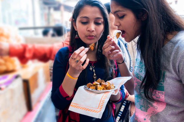 girls eating aloo chaat street food - food stock pictures, royalty-free photos & images