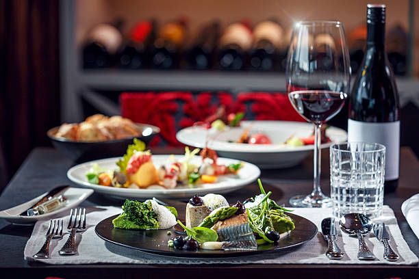 gourmet dinner: delicate fish carefully arranged with green vegetables - food stockfoto's en -beelden