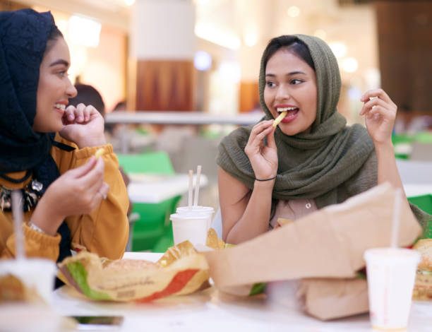 grabbing a bite to eat - junk food stock pictures, royalty-free photos & images