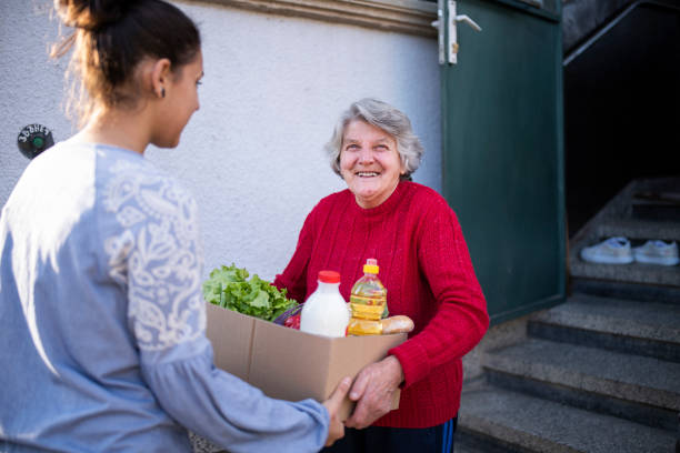 grandchild delivering freshness food to her grandmother. - food stock pictures, royalty-free photos & images