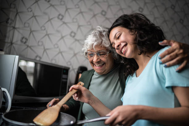 granddaughter and grandmother cooking at home - food stock pictures, royalty-free photos & images