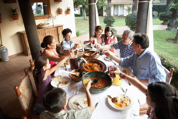 grandparents, parents and children (7-15) toasting at dinner - food stock pictures, royalty-free photos & images